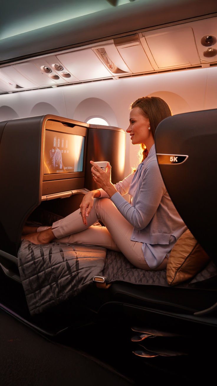 Traveler with coffee in a business class suite at golden hour