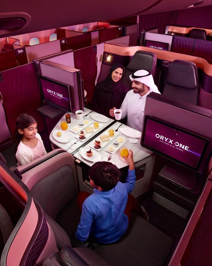 Family dining together across business class suites